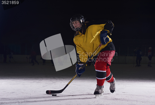 Image of teen ice hockey player in action