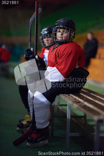 Image of children ice hockey players on bench