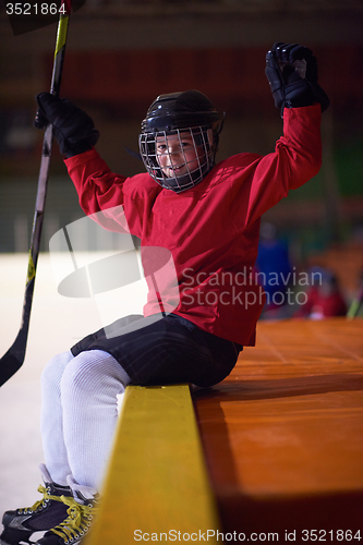 Image of children ice hockey players on bench