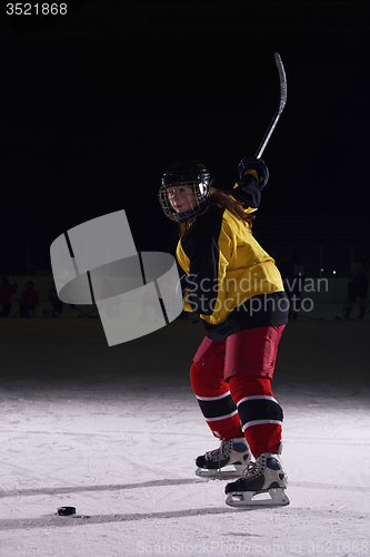 Image of teen ice hockey player in action