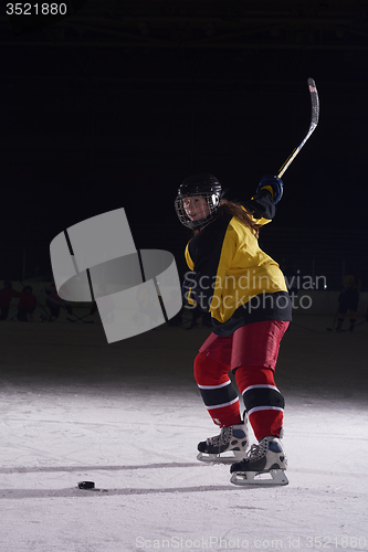 Image of teen ice hockey player in action