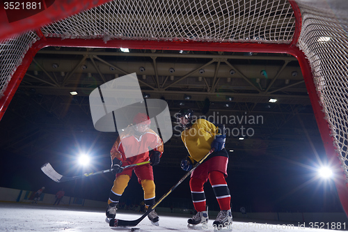 Image of teen ice hockey sport  players in action