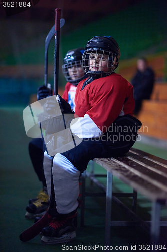 Image of children ice hockey players on bench