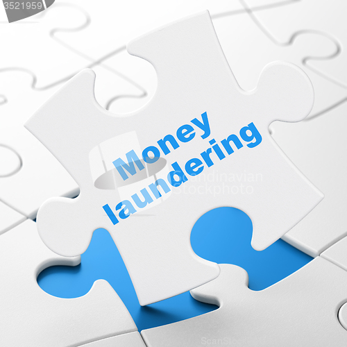 Image of Currency concept: Money Laundering on puzzle background