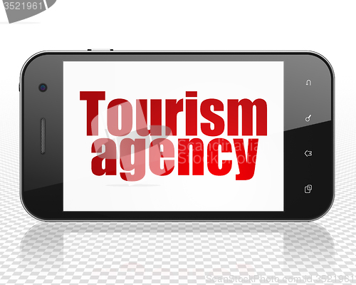 Image of Travel concept: Smartphone with Tourism Agency on display
