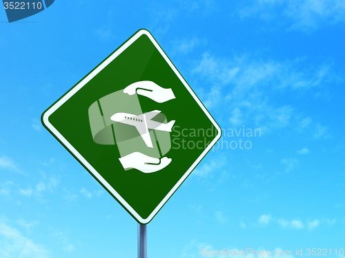 Image of Insurance concept: Airplane And Palm on road sign background