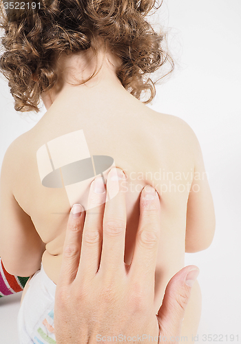 Image of Pediatrician having health check on unrecognizable child with fi