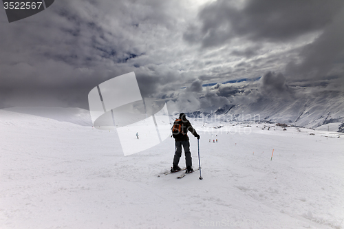 Image of Skiers on ski slope before storm