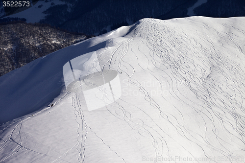 Image of Top view on off piste slope with snowboarders and skiers in even