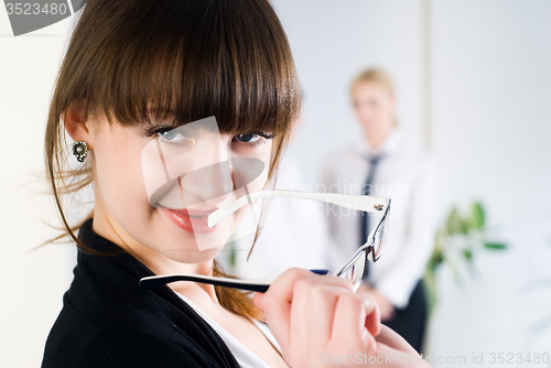 Image of Young attractive business lady in office