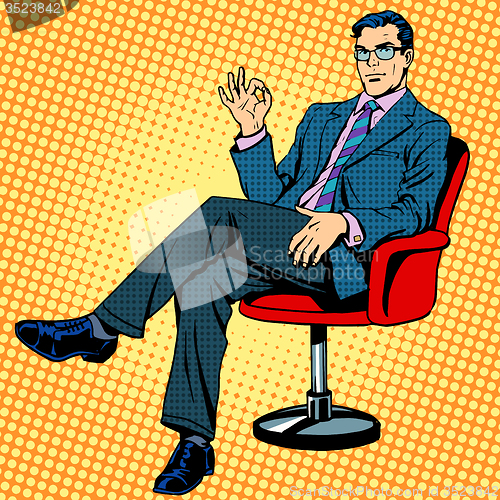 Image of Businessman sitting in an armchair gesture okay