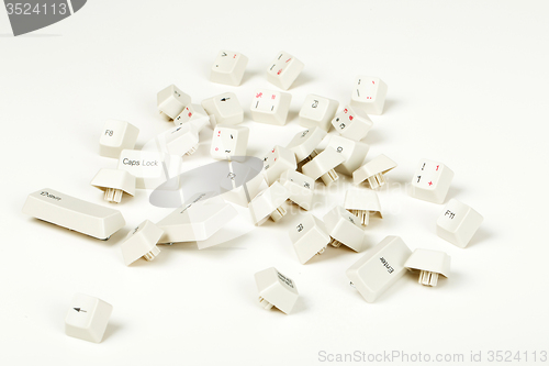 Image of scattered keyboard keys on white 