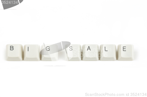 Image of big sale from scattered keyboard keys on white