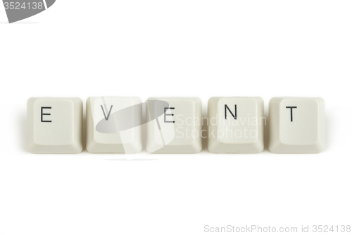 Image of event from scattered keyboard keys on white