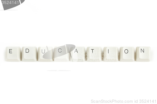 Image of education from scattered keyboard keys on white