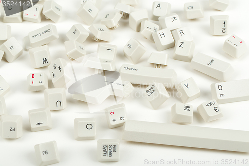 Image of scattered keyboard keys on white 