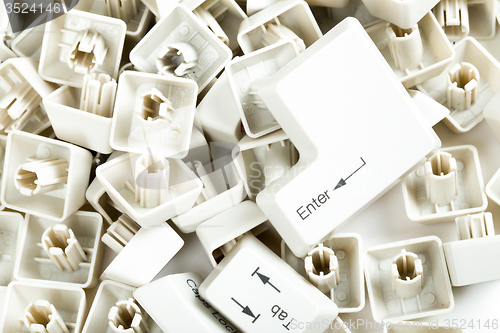 Image of scattered keyboard keys on white 