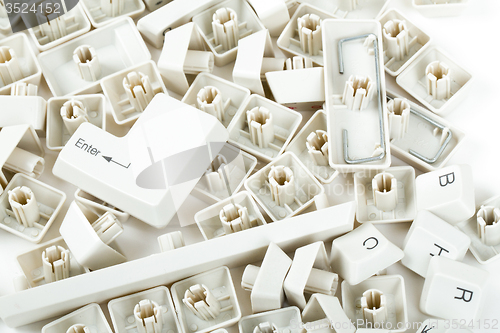 Image of scattered keyboard keys on white 