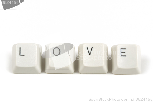 Image of love from scattered keyboard keys on white