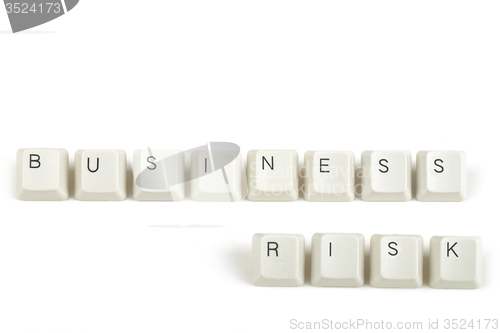 Image of business risk from scattered keyboard keys on white