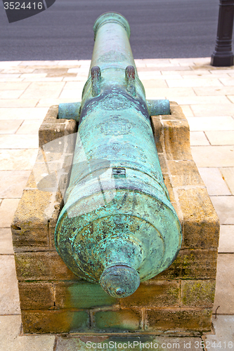 Image of bronze cannon in africa morocco  green  and the  