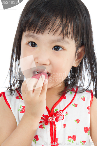 Image of Asian Chinese little girl eating strawberries