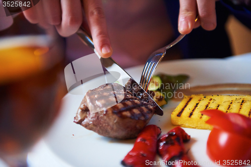 Image of business man eating tasty beef stak