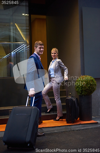 Image of business people couple entering  hotel