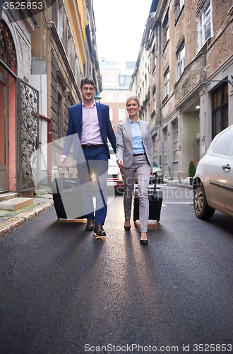 Image of business people couple entering  hotel