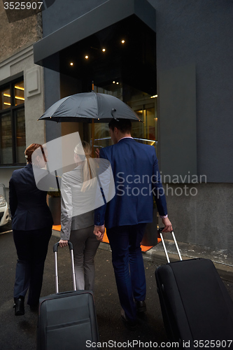 Image of business people couple entering  hotel