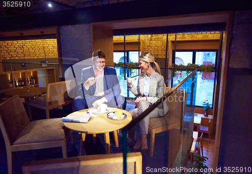 Image of business couple take drink after work