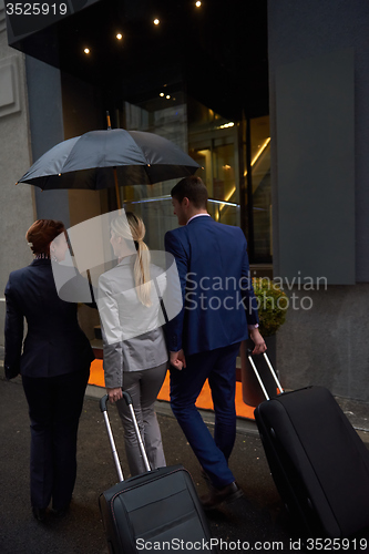 Image of business people couple entering  hotel