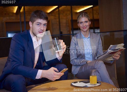 Image of business couple take drink after work