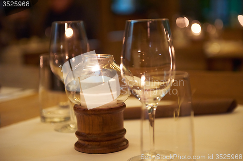 Image of Wine bottles on a wooden shelf.