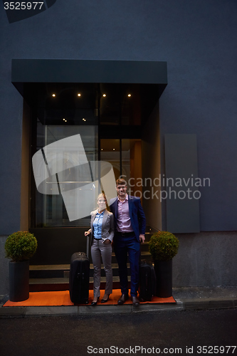 Image of business people couple entering  hotel