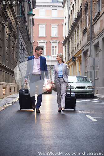 Image of business people couple entering  hotel