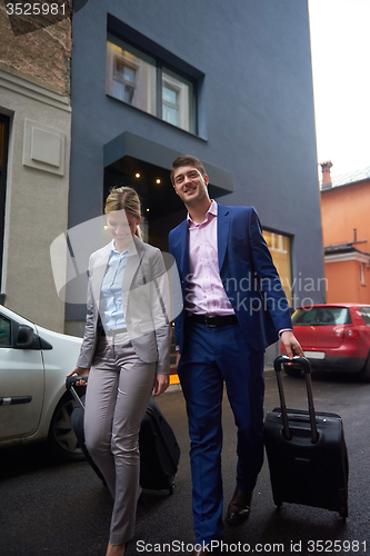 Image of business people couple entering  hotel