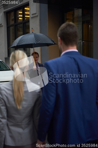 Image of business people couple entering  hotel