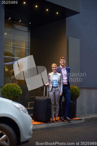 Image of business people couple entering  hotel