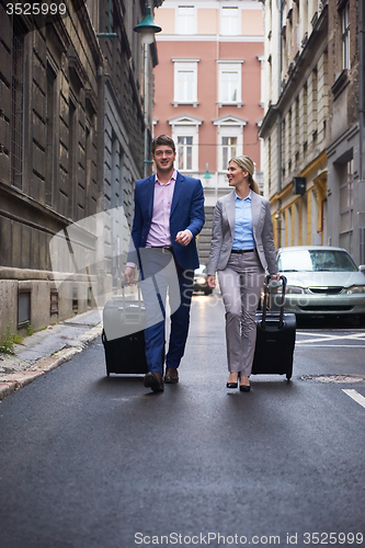 Image of business people couple entering  hotel