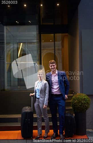 Image of business people couple entering  hotel