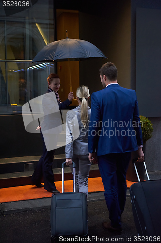 Image of business people couple entering  hotel