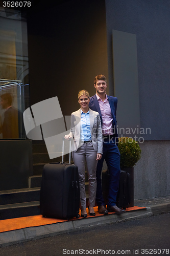 Image of business people couple entering  hotel