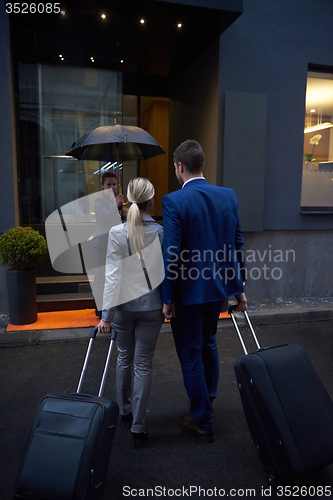 Image of business people couple entering  hotel