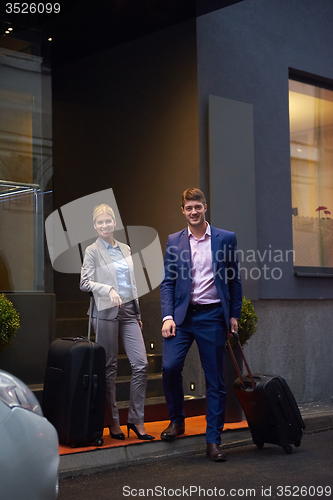 Image of business people couple entering  hotel