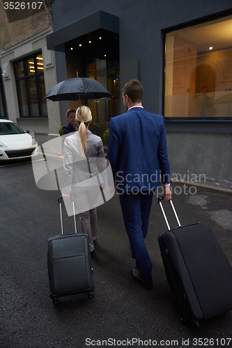 Image of business people couple entering  hotel