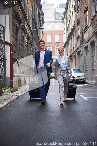 Image of business people couple entering  hotel