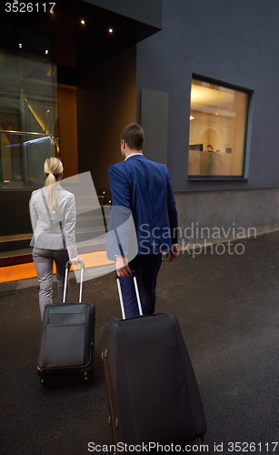 Image of business people couple entering  hotel