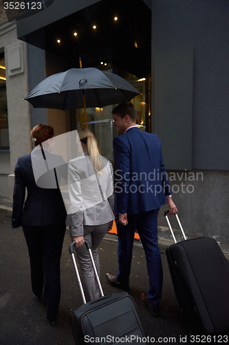 Image of business people couple entering  hotel