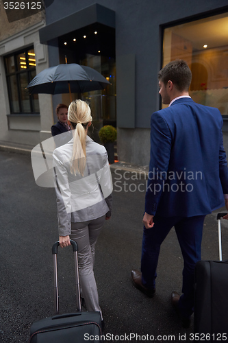 Image of business people couple entering  hotel